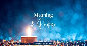Warm candlelight glowing on a bed of jewels, with a soft bokeh background symbolizing light, hope, meaning and purpose.